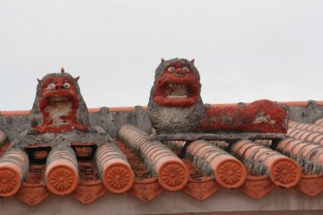 Its unusual to see two shisa dogs on a roof and rare to see them placed next to each other