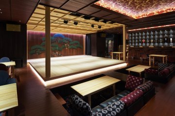 The centerpiece of Suigian, a warm, all-wood stage, a sacred space that appears to be floating. 
