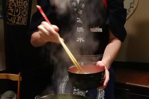 Preparing the first bowl of nabekko
