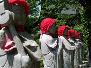 Jizo statues with a temple building in the background