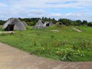 The structures with thatched roofs are particularly intriguing