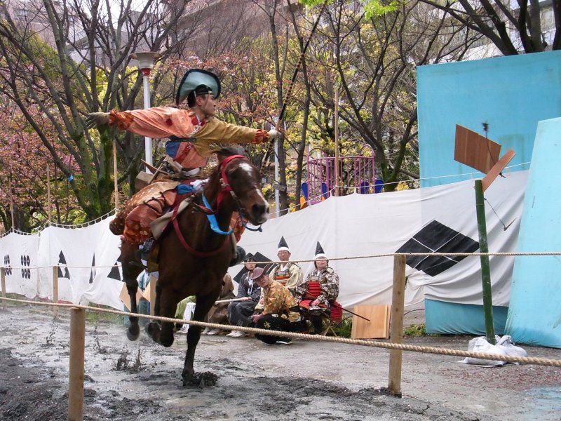 A mounted archer releasing his arrow