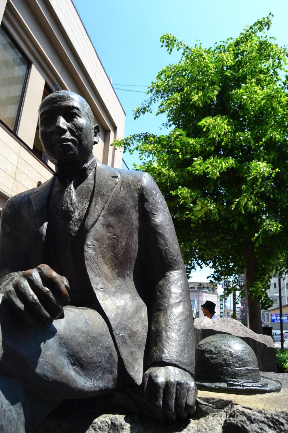 A full statue of Miyawa Kenji sits beside the road of Zaimokucho Street,  not far from the memorial site.