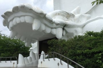 The entrance at the base of the statue is a dragon's mouth! It looks like you are on the menu!