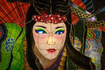  A larger-than-life Tachineputa festival float featuring a woman's face 