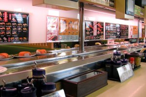 Tables are located along the conveyor belt