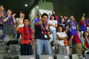 Happy family: Celebrating a 2-0 win for Tokyo.