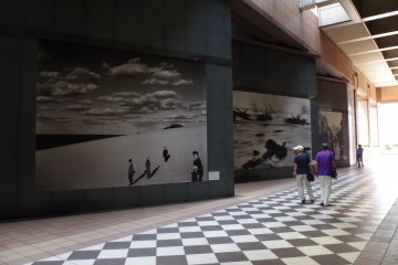 Corridor leading to the side entrance displaying the enlarged works of iconic photographs by local and international photographers