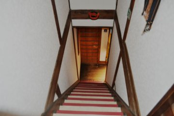 Stairs from the second floor (rooms) to the shared area
