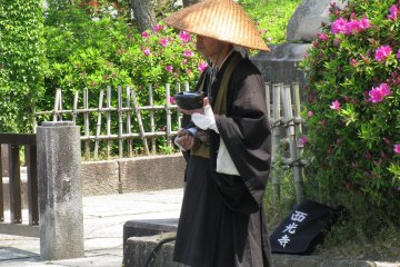 A monk accepting donations