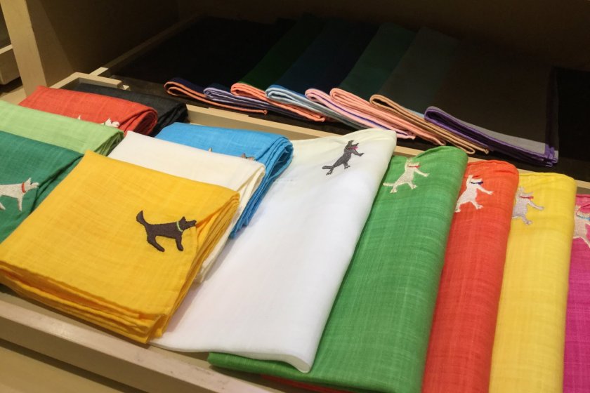 Whimsical handkerchiefs: dogs tugging the edge.