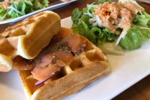 The savory waffles are topped with smoked salmon