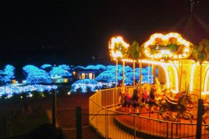Carousel and yurts lit up at night