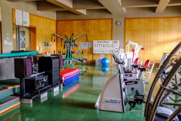 The training room features cardio equipment and weight machines. There is also detailed information on stretching and safety precautions