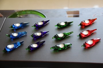 <p>A gift store now takes up a considerable amount of the hotel lobby, but there are colorful eye-catcing items on sale there such as these Ryukyuan stained glass chili pepper chop stick holders</p>