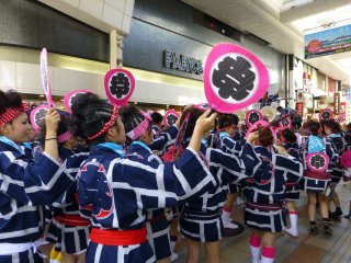 A group makes its way down Shimotori shopping arcade
