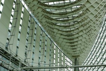 Tokyo International Forum features swooping curves of steel truss and glass; the outside is shaped like an elongated boat