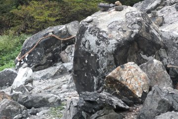The rock sits on a desolate mountainside