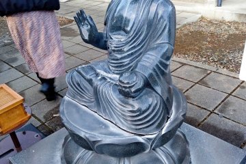 Buddhist statue to pour water on