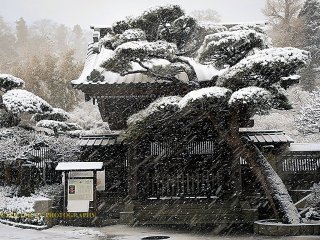 The main gate to the temple in a winter snowstorm.