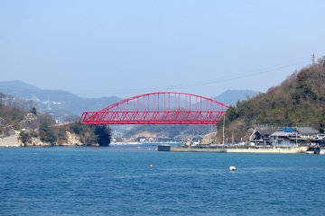 The vibrant red Mukaishima Bridge