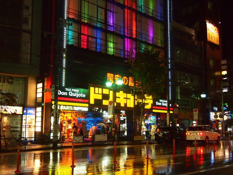Don Quijote (Roppongi) is housed in a colourful building. Its colours bounce off the wet pavements on a rainy day.