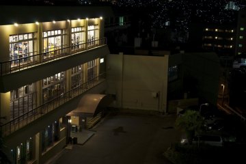Front of Nisshokan Hotel at night