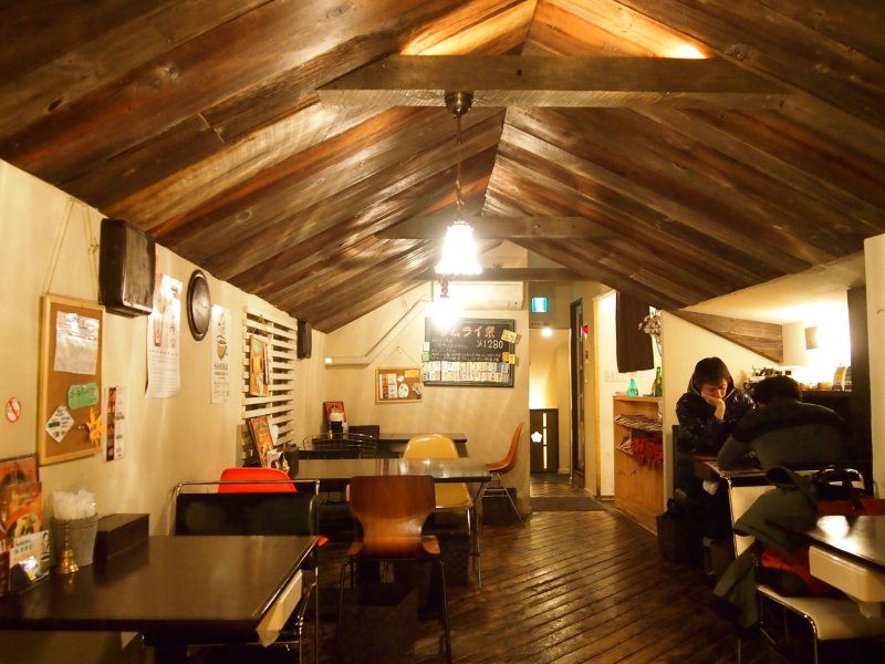 The cosy interior of the top level of the restaurant that looks like a little hut.