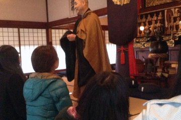 <p>A priest discusses the finer points of Zen Buddhism before a group mediation session.</p>
