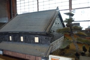 This is a 1/100 scale model of the Shinohara residence and property including three large stone warehouses, just prior to the 1949 bombing attack of the city.&nbsp;
