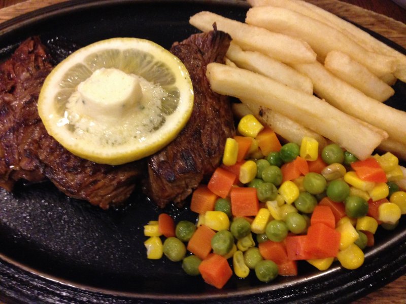 <p>The Big Heart 200 gram special sirloin steak is served with mixed vegetables, steak fries, rice or bread, soup and salad for 1,480 yen</p>