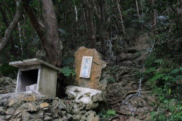 <p>A shrine on the mountain side; ropes in the background lead up a very direct and steep approach up to the nearby mountain peaks</p>