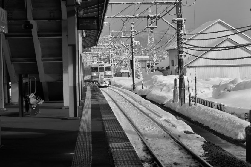 A JR Joetsu line train arrives at Urasa Station with snow all around. Get into the cozy train and it will wind through some of the most beautiful landscapes and give you great views of Niigata's snow country.