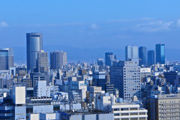 <p>Afternoon view of&nbsp;Osaka City with a faint line of the mountain range, which can be seen much more prominently on a clear day</p>