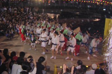 Shinmachi Riverside. One of the Awa Dance groups is dancing on the stage near Ryogoku Bridge