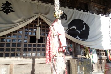 <p>Bell rope in front of Main Hall with bibs to pray for the safety of children</p>